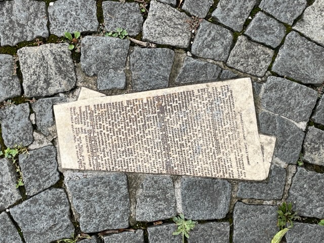 A single flyer sketched into the cobblestones as part of the White Rose Memorial 