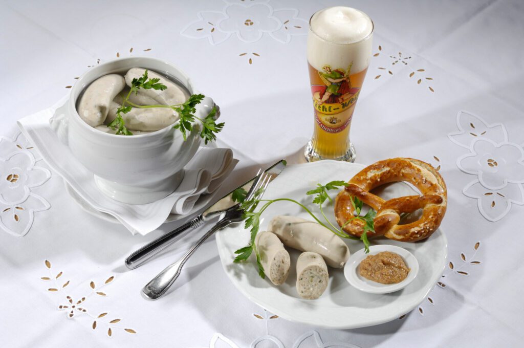 A traditional Weisswurst breakfast, served with a brezel and sweet mustard
